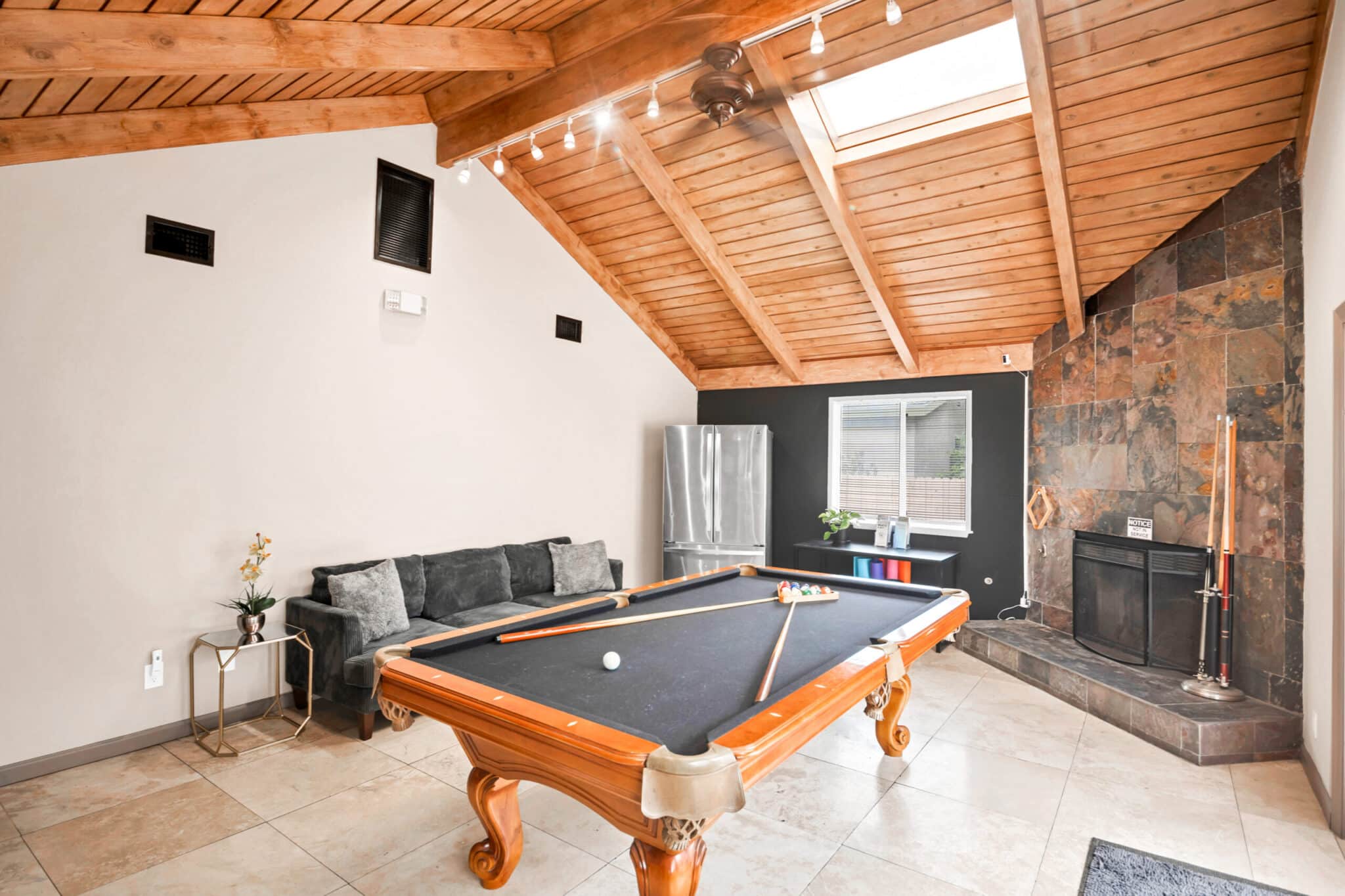 Pool table and stone fireplace lounge at Northridge Addiction Treatment Center
